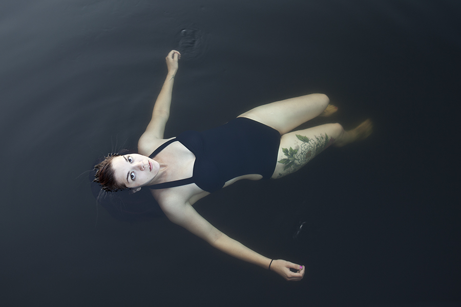 A woman floats on her back in a lake near Big Moose, New York