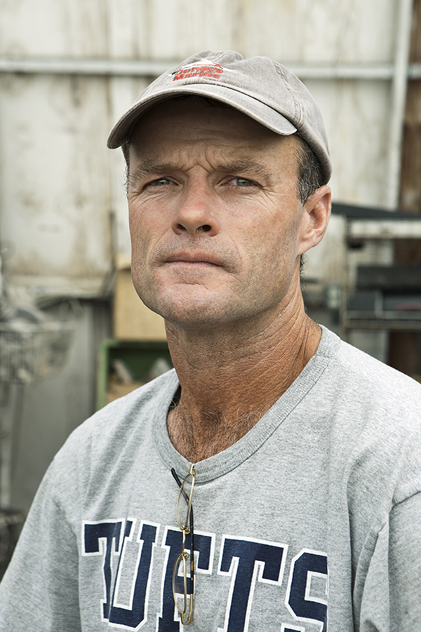 A portrait of an aging man with deep lines in his face from years of working in the sun and on boats