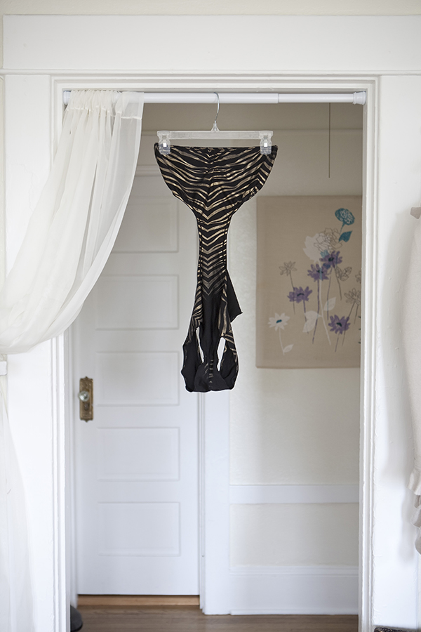 A leopard print outfit worn by a stripper in Seattle, Washington hangs in the doorframe of her living room